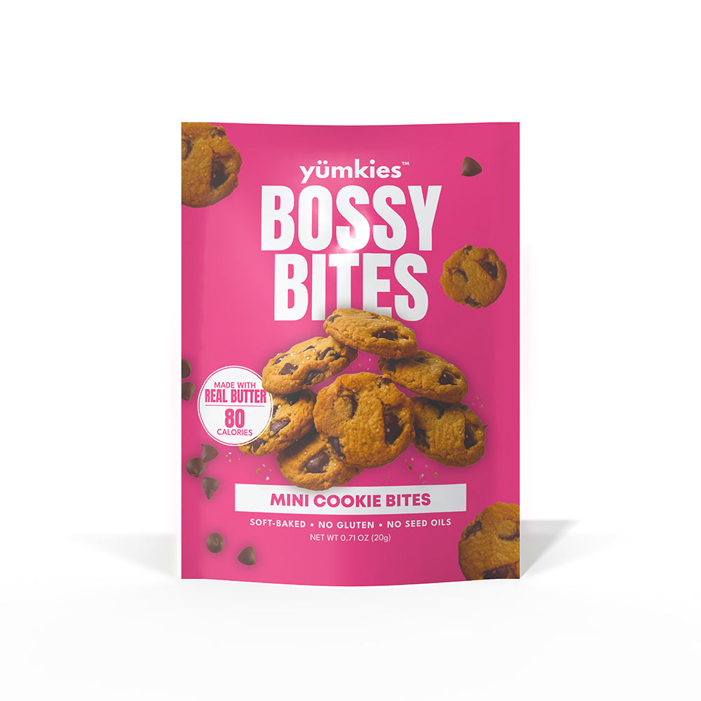 A package of yumkies Bossy Bites Mini Cookie Bites on a clean white background. The packaging is bright pink with white text and an image of chocolate chip cookies.