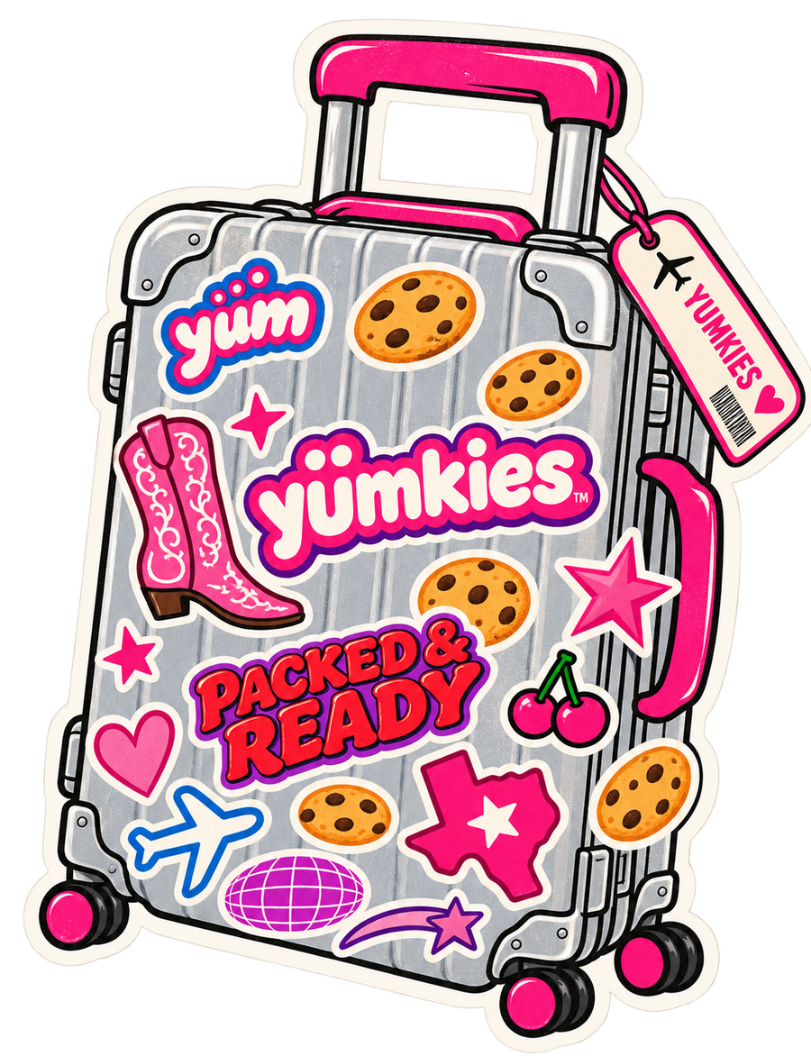 Y2K-inspired Yumkies travel suitcase sticker featuring a silver rolling suitcase decorated with pink Yumkies logos, chocolate chip cookies, cowboy boots, stars, and a Packed & Ready graphic.